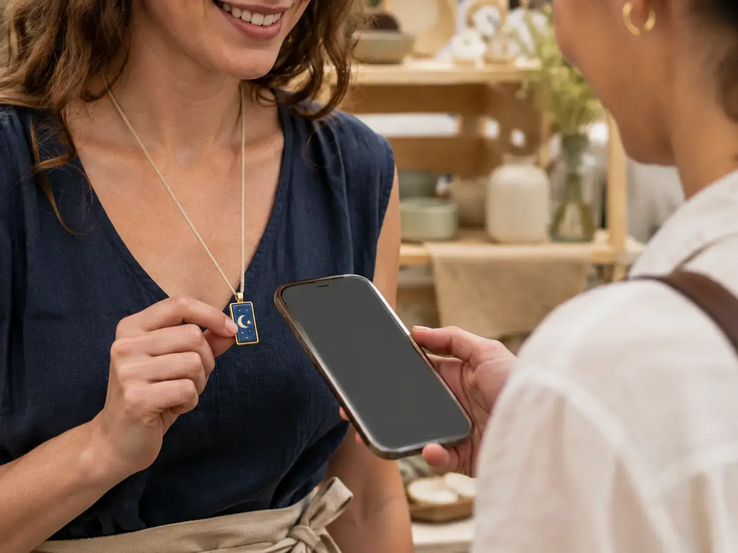 Maker sharing contact details by tapping a phone near a ceramic HavenTap tag